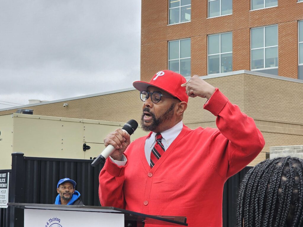 Curtis Jones speaking into a microphone at a rally