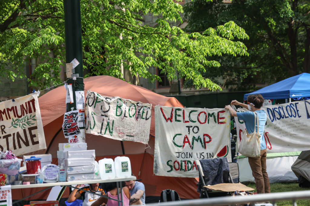 05 01 2024 k paynter reduced dave mccorkmick_-3 Members of a protest encampment at UPenn hang signs around their camp on May 1, 2024.