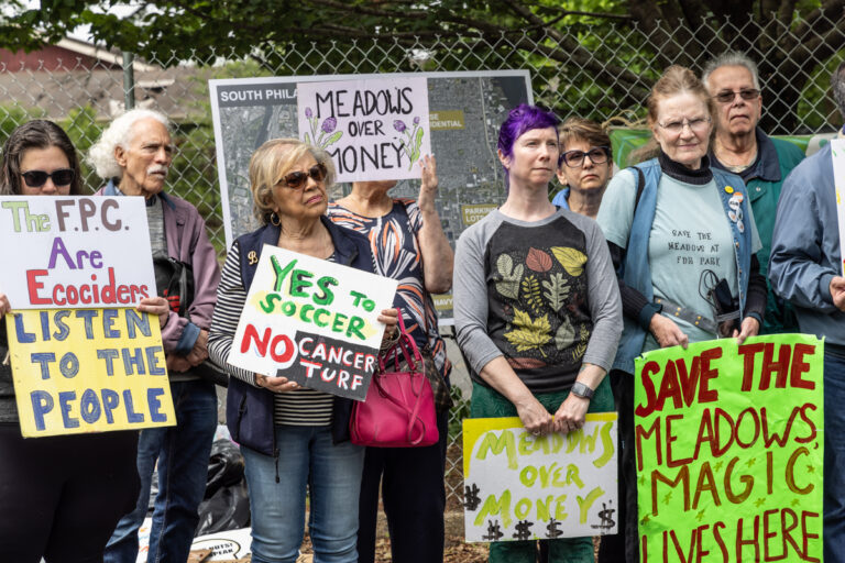 activists hold signs in FDR Park