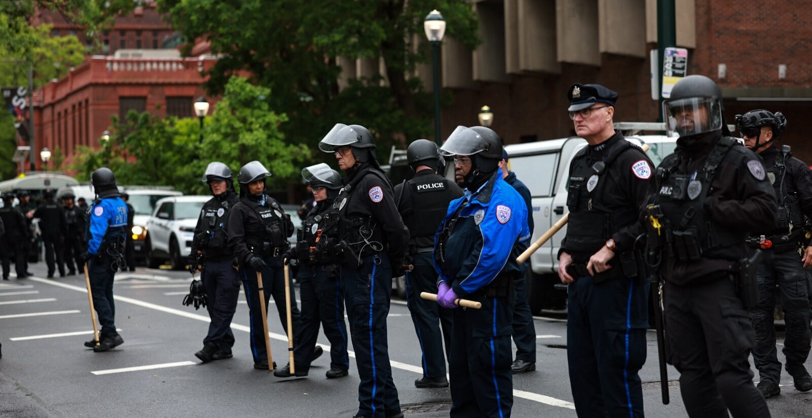Police in riot gear block access to Penn's campus green where crews were clearing the protest encampment.