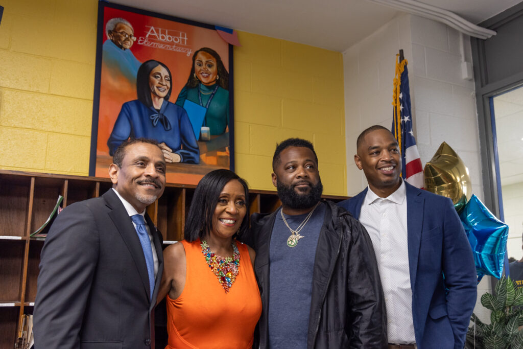 05 22 2024 k paynter reduced joyce abbott honored-10 Philadelphia Superintendent Dr. Tony Watlington (left); retired teacher Joyce Abbott (center-left); painter Ivben Taqiy (center-right); and Andrew Hamilton School principal Torrence Rothmiller (right), in front of Taqiy’s portrait of Abbott, her mother and former student Quinta Brunson, who created the show