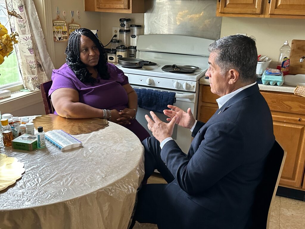 2024-05-15-Xavier-Becerra-home-health-care-philadelphia-1 Xavier Becerra and Lolita Owens sit at a kitchen table
