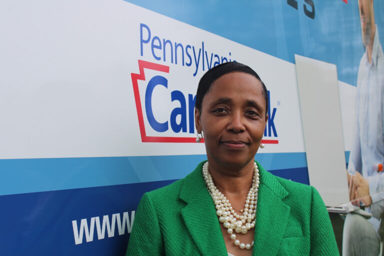 Billie Barnes next to the Bucks County Workforce on Wheels bus