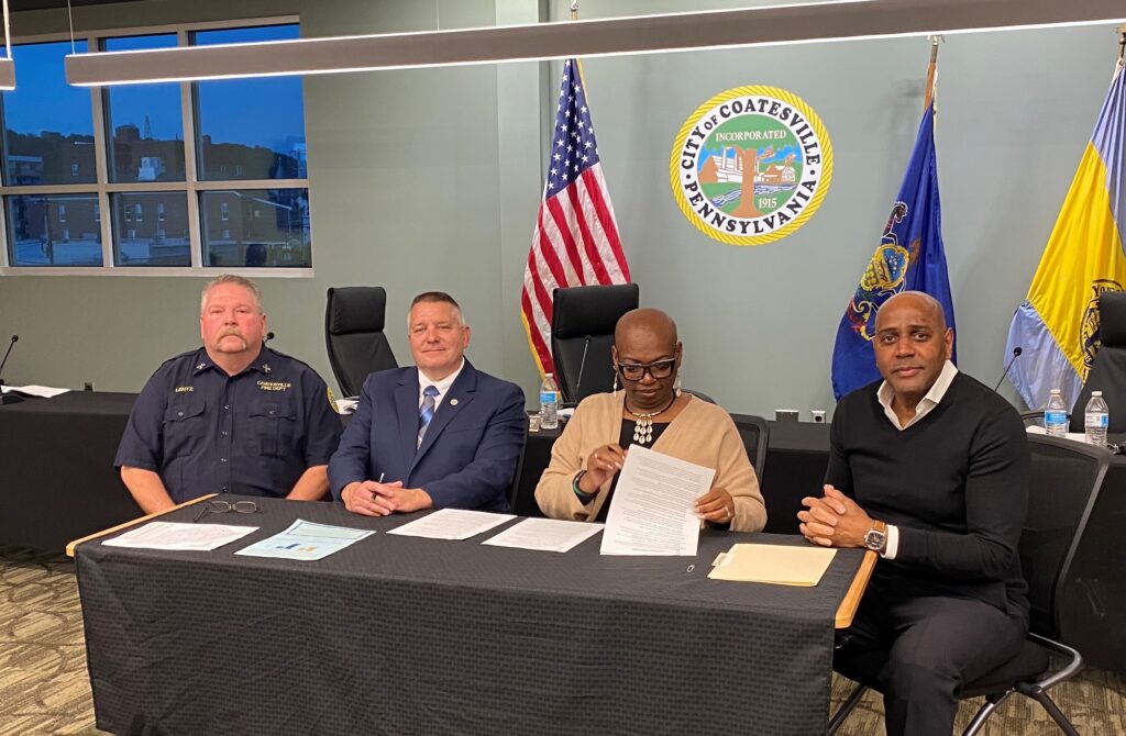 officials sitting at a table with documents