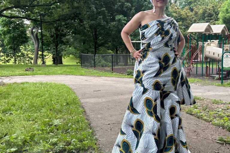 a woman smiles in a dress