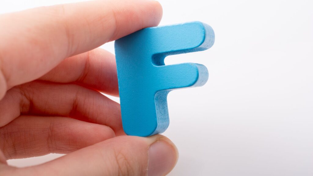 F-Word Hand hold a blue letter F