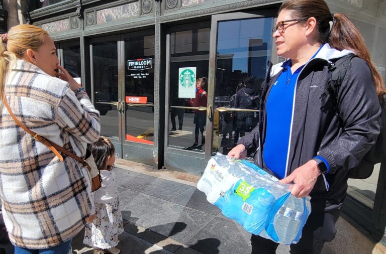 shoppers holding case of water