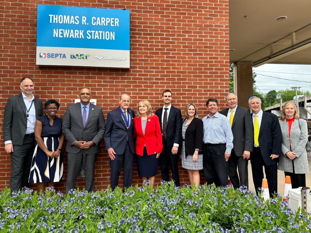 carper-train-jpg-2024-05-17-2 Tom Carper posing with people in front of the station