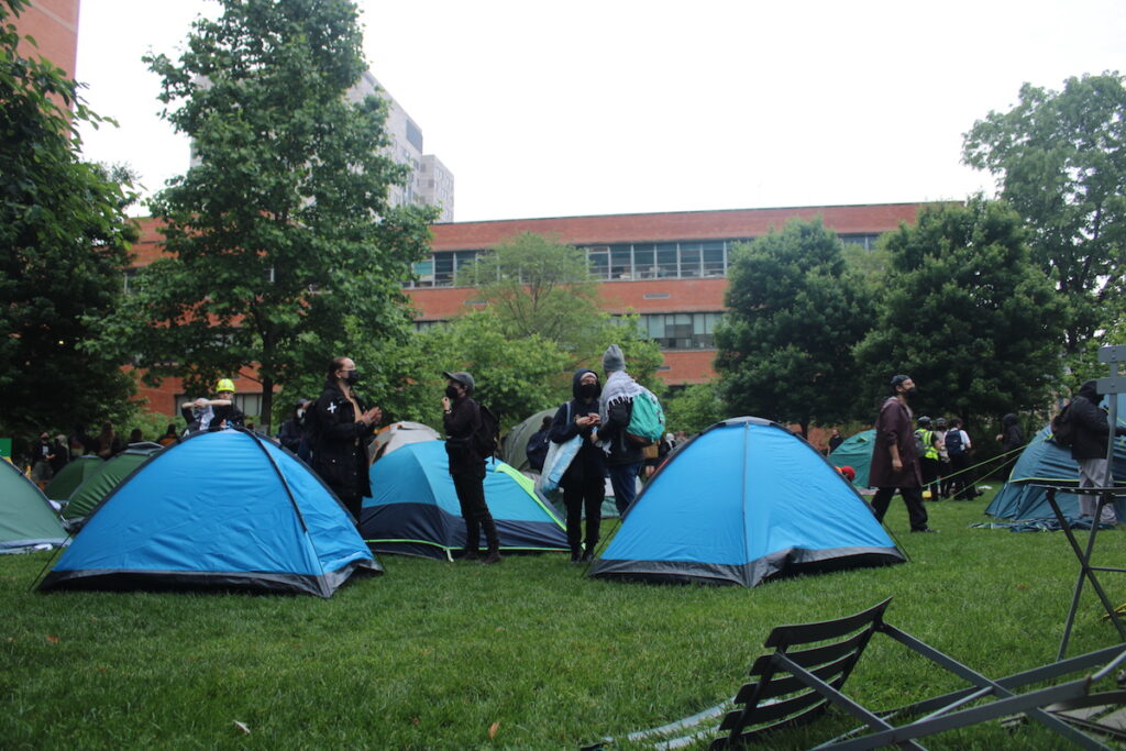 gaza-protest-12 Hundreds of Pro-Palestinian protesters marched from City Hall toward University City on Saturday. They linked arms and encircled a group of people setting up tents on Drexel University's campus.