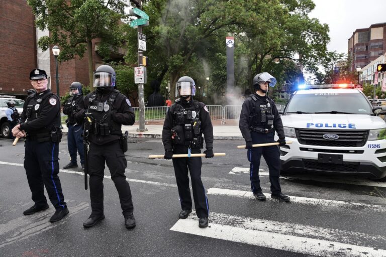 Police in riot gear block access to Penn's campus green where crews were clearing the protest encampment.