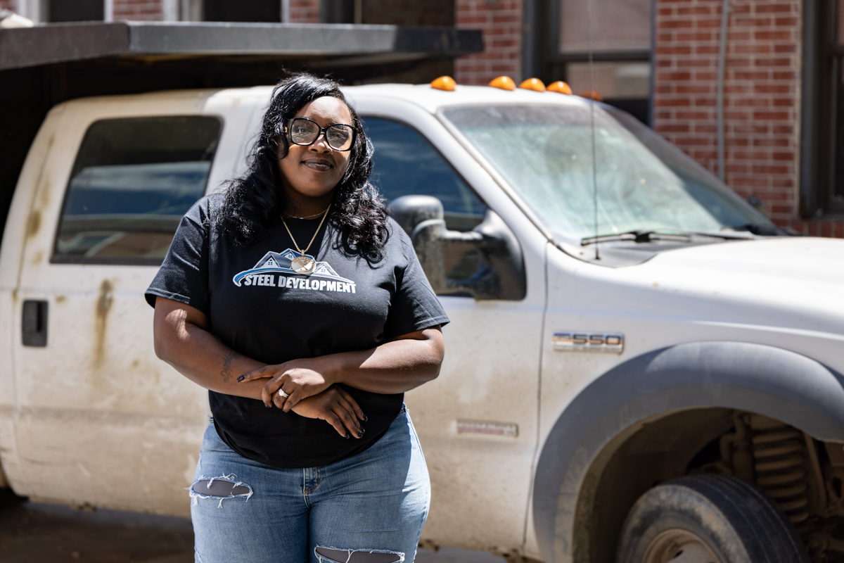 Charly Bass in front of a work truck