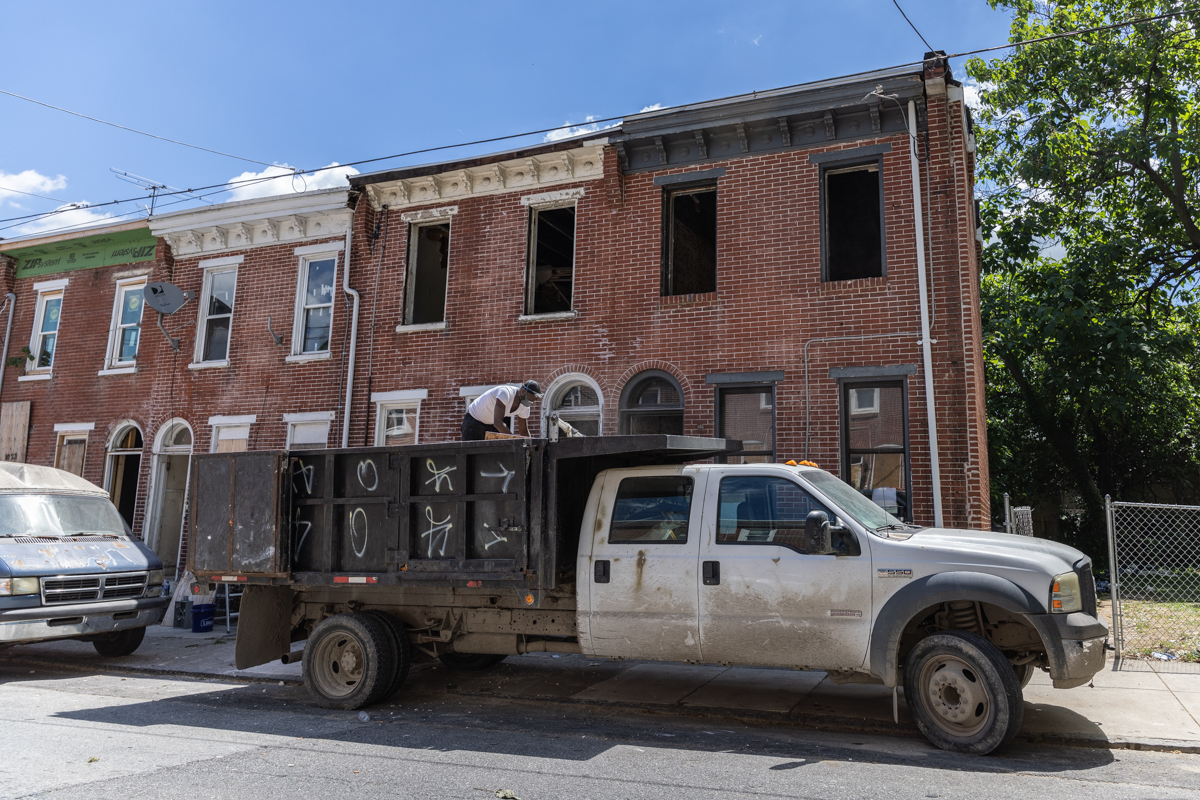 a construction truck sits in front of a property