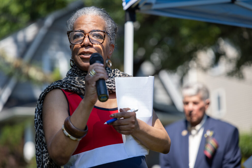 Adrienne Rhode addressing the crowd on a microphone