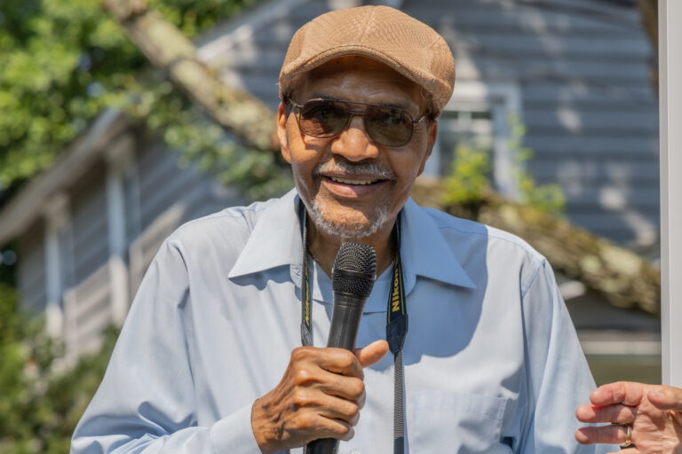 Alfred Dansbury speaking into a microphone
