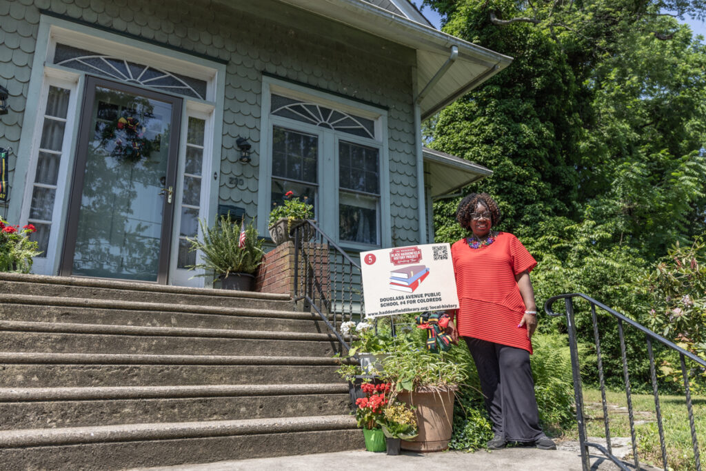 Linda Armstead in front of her home