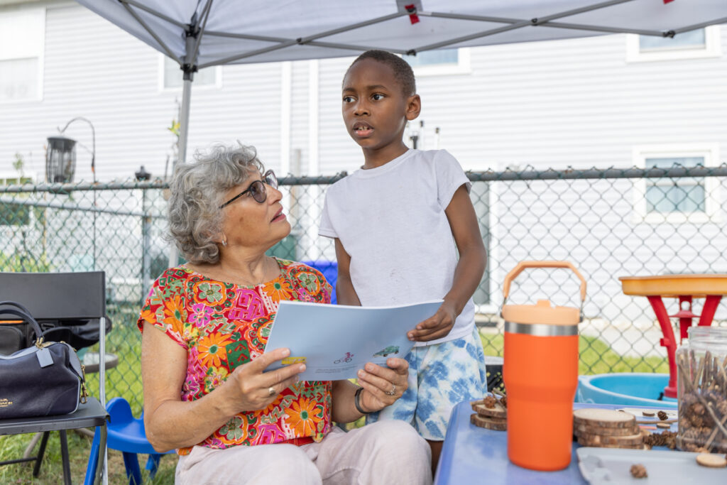 Lorna Rosenberg with a child under a tent