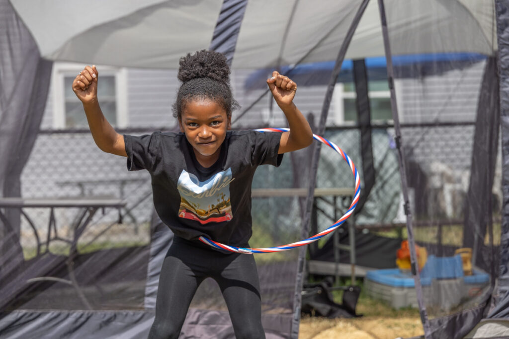 A child using a hula hoop