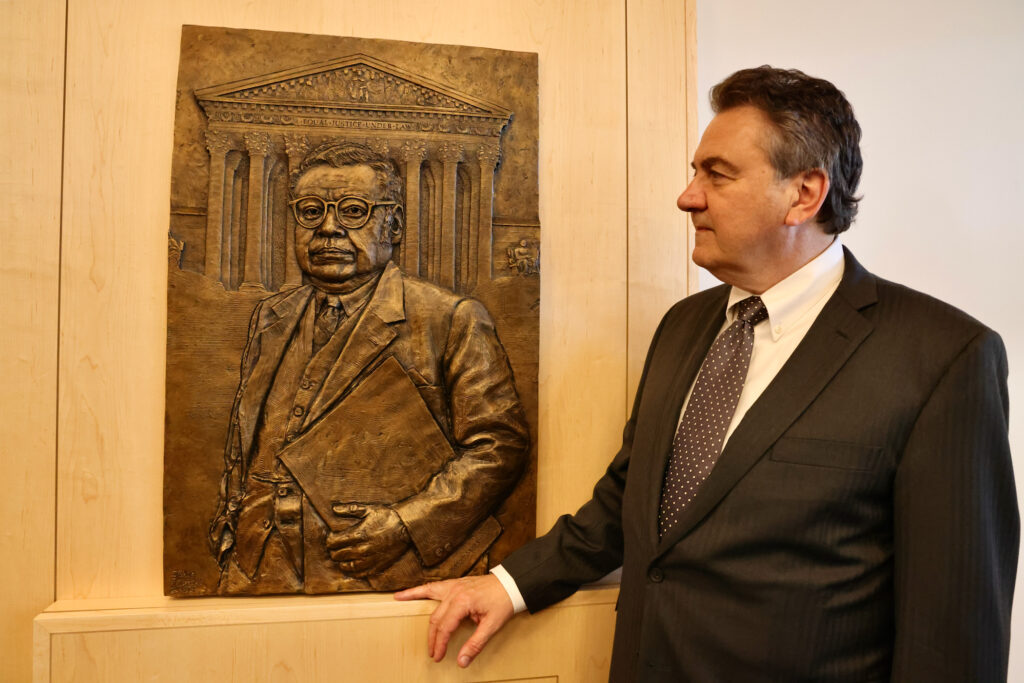 A bas-relief portrait of William Thaddeus Coleman Jr. hanging on the wall