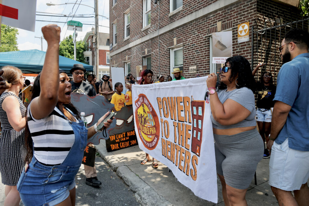 2024 06 18-e lee-philadelphia frankford-odin properties renters protest fist Renters march and hold a sign reading Power to the Renters