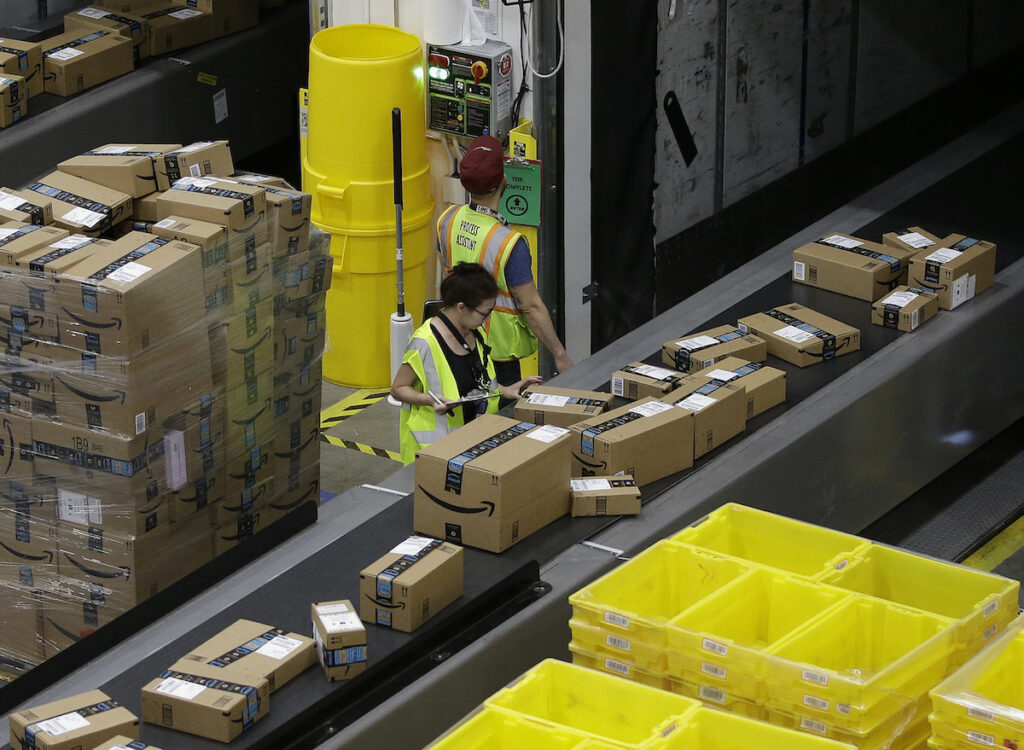 Packages move down a conveyor system were they are directed to the proper shipping area at the new Amazon Fulfillment Center Friday, Feb. 9, 2018, in Sacramento, Calif. (AP Photo/Rich Pedroncelli)
