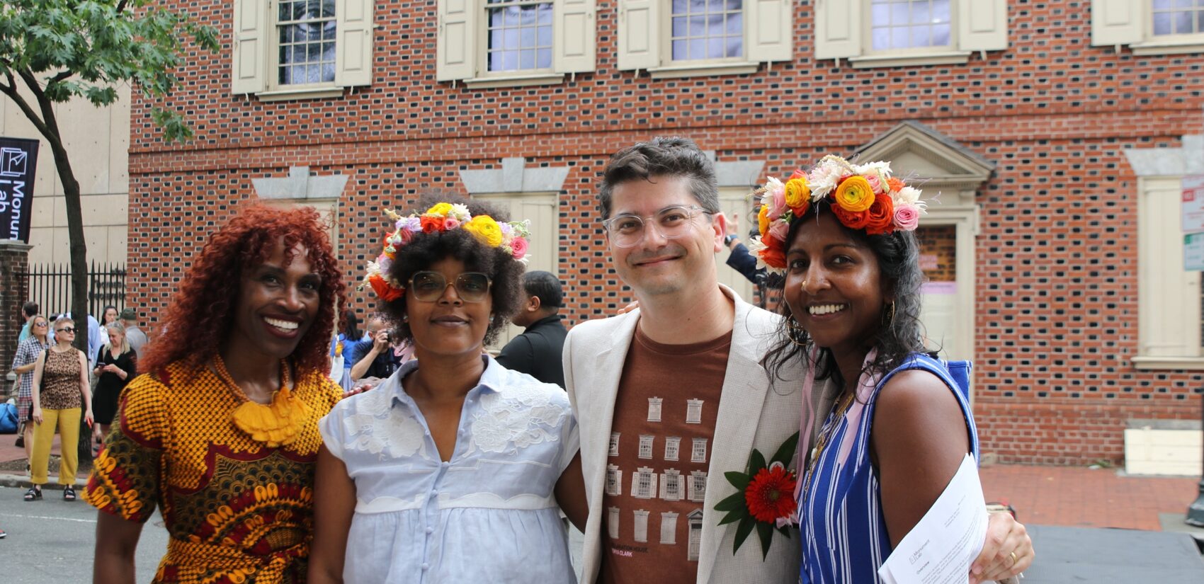 Chief Cultural Officer Val Guy, Monument Lab's Yolanda Wisher and Paul Farber, and Princeton University professor Anna Arabindan-Kesson pose in front of the Declaration House exhibit during its unveiling on June 24, 2024. (Cory Sharber/WHYY)