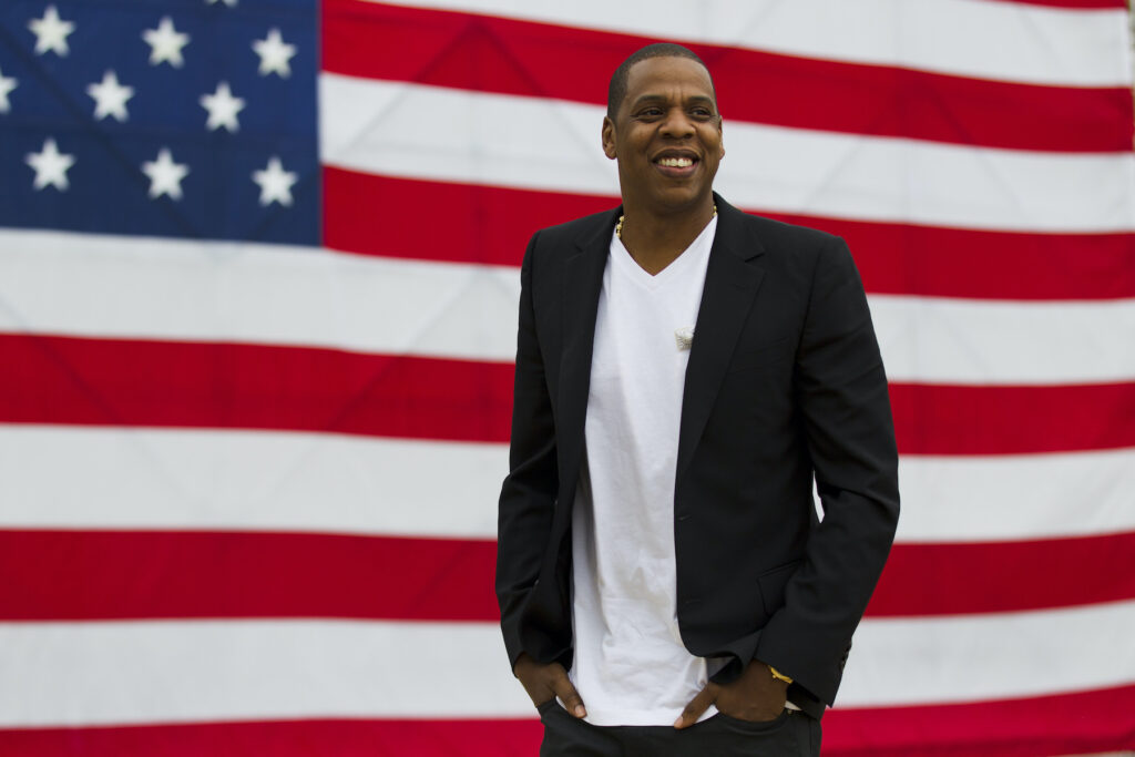 Music-Made in America Jay-Z standing in front of a large American flag