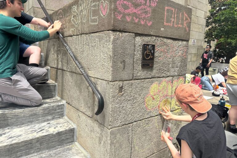 students graffiti a campus building
