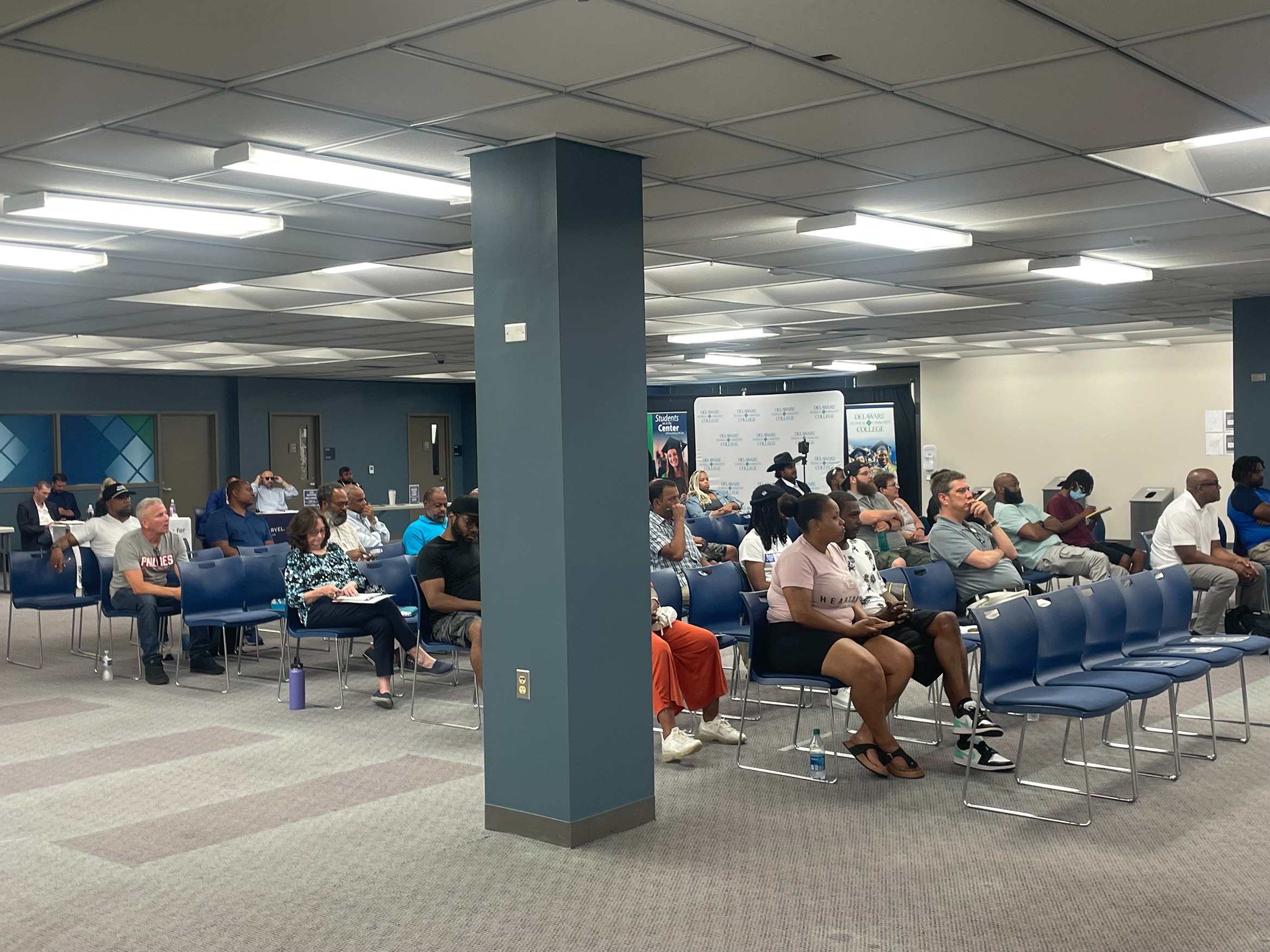 Dozens of people sit for a workshop
