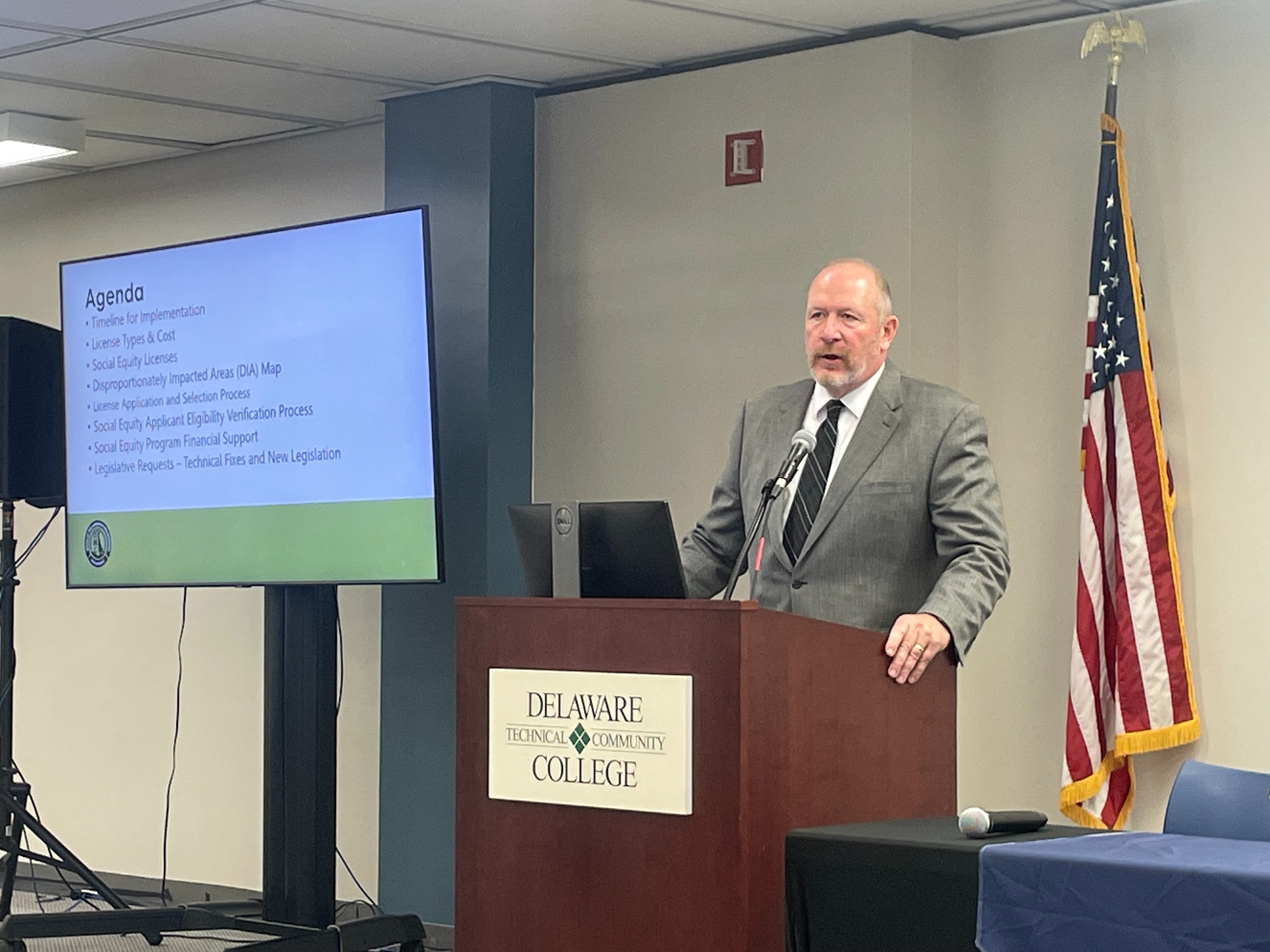 Paul Hyland speaks at a podium