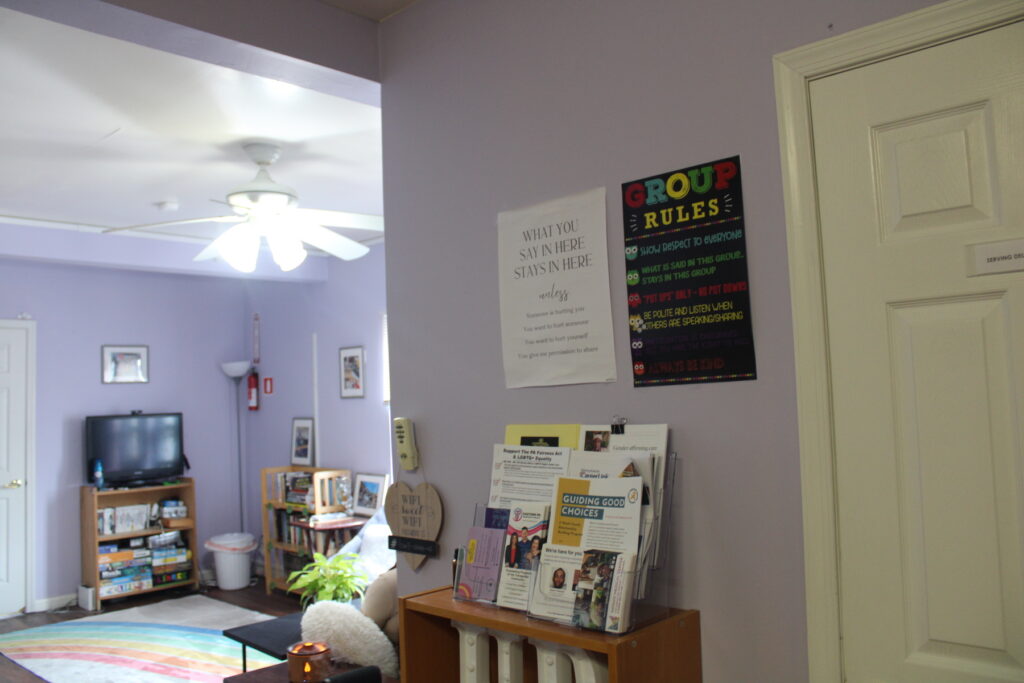 Signs on the wall listing 'group rules' inside the community center