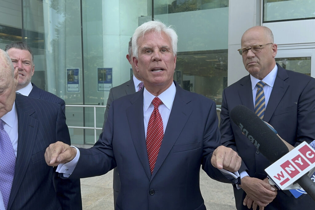 Influential Democratic power broker George Norcross, center, speaks outside the justice complex in Trenton, N.J., Monday, June 17, 2024, about being charged with racketeering and other charges in connection with government issued tax credits.