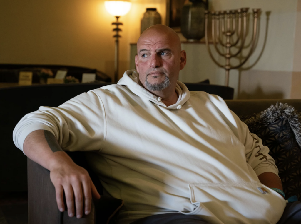 John Fetterman posing inside his home.