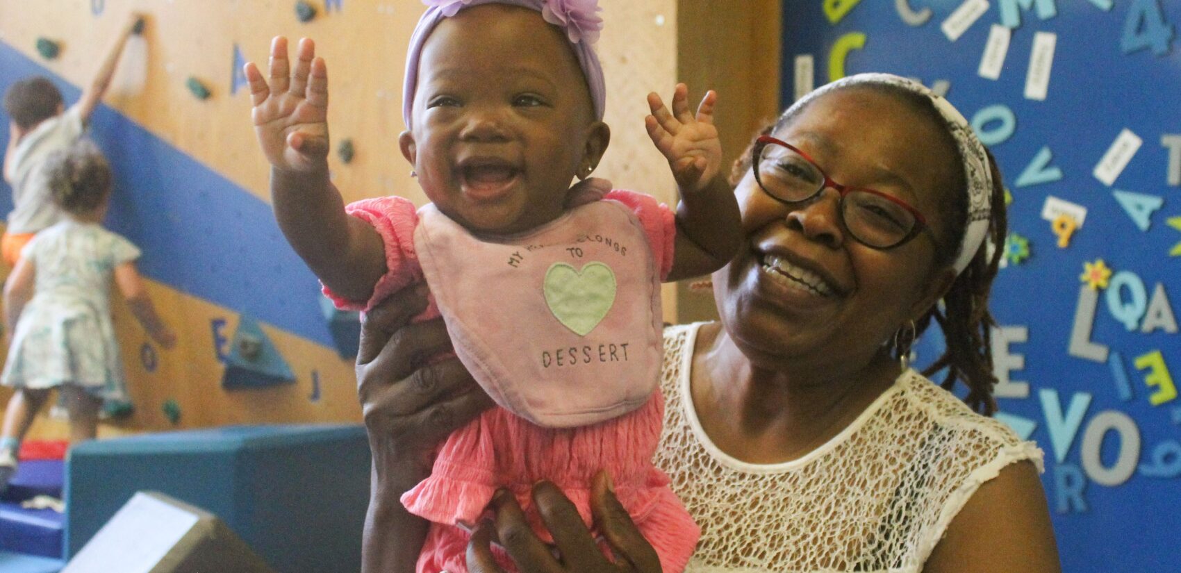 Families and children visit the Cecil B. Moore Library in Philadelphia on Sat., June 22, 2024 to celebrate the launch of the Philly Joy Bank and escape the heat wave at one of the city’s designated cooling centers. (Nicole Leonard/WHYY)