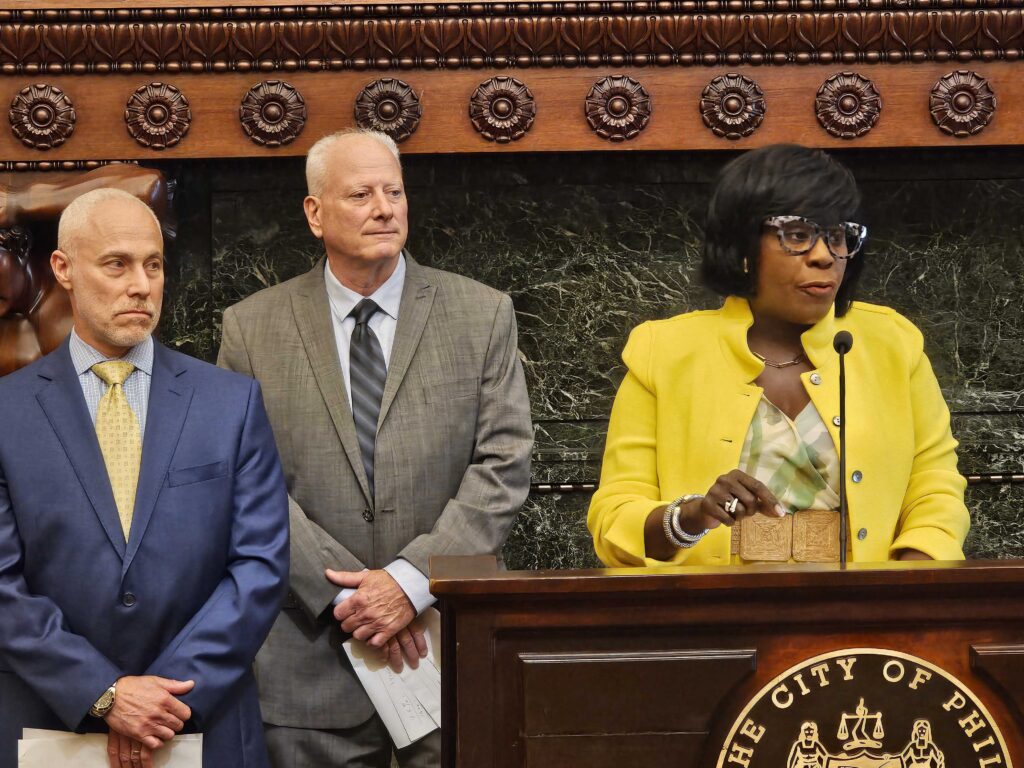 mayor-cherelle-parker-Eric-Desiderio-Michael-Resni Mayor Cherelle Parker (right), Local 159(b) Eric Desiderio (middle) and Michael Resnik, prisons commissioner, speak at the arbitration announcement June 17, 2024. (Tom MacDonald, WHYY)