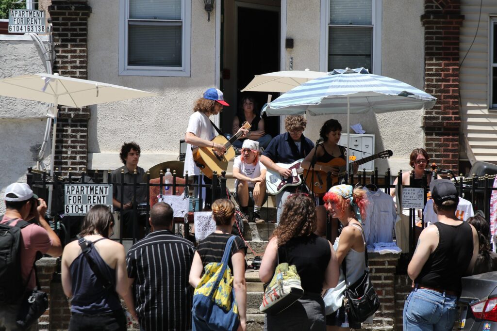 west-philly-porchfest-2024-11 Porchfest attendees watch a band