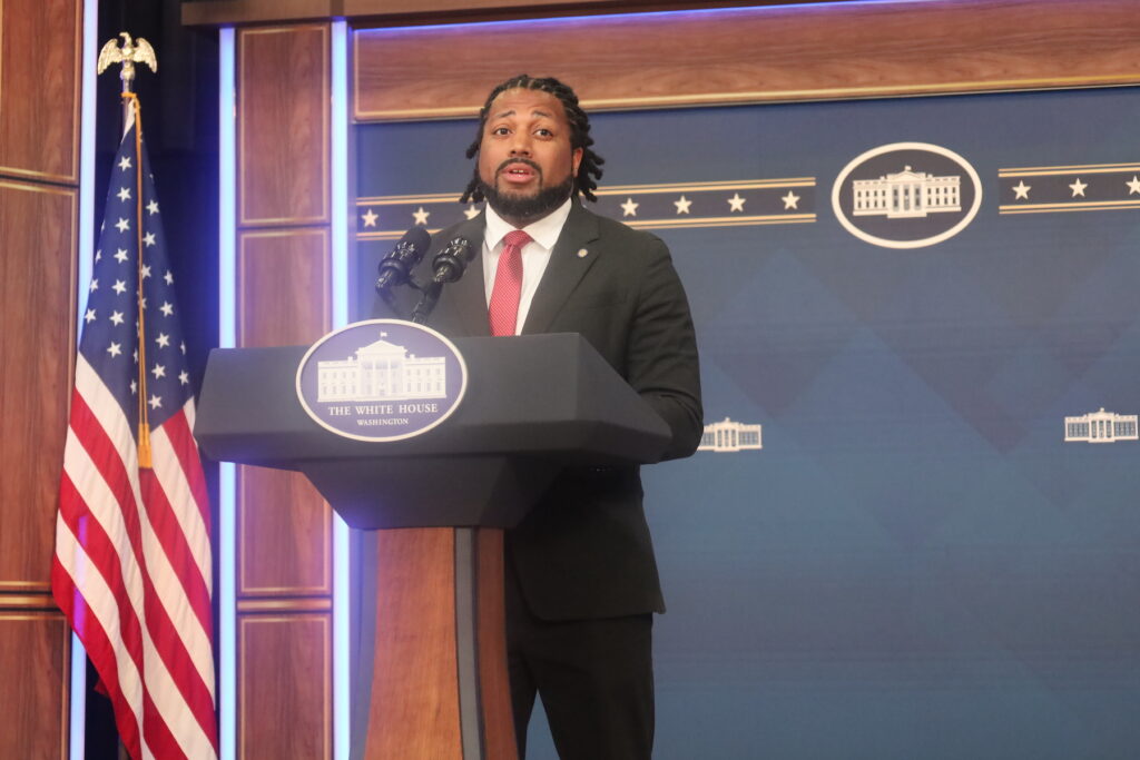 Greg Jackson speaks at a podium