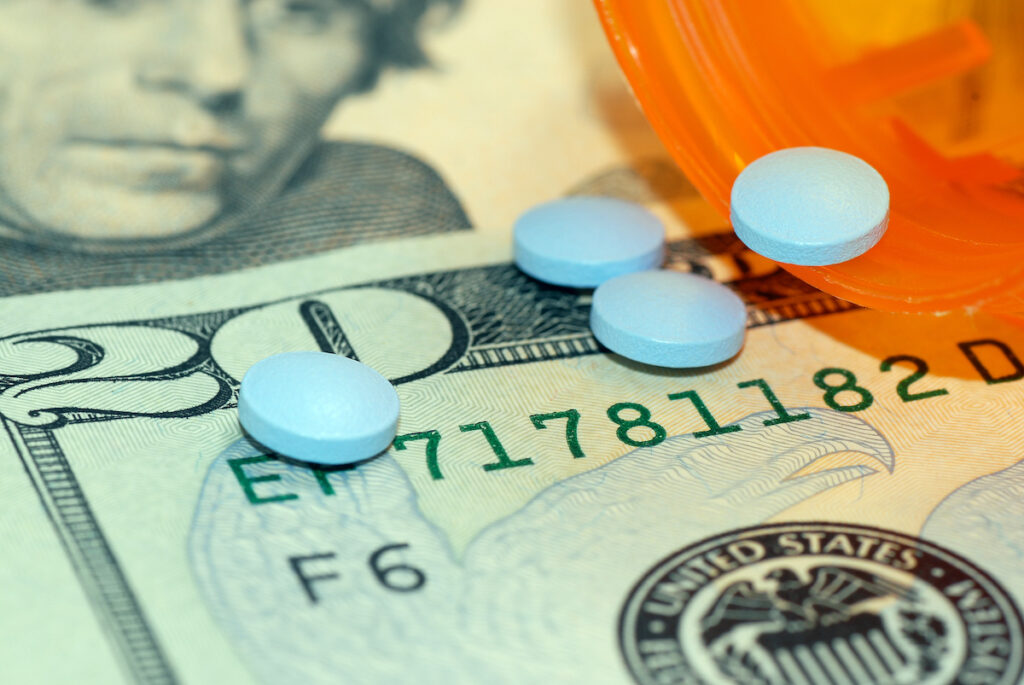 Medication Cost Medication pills on top of US currency. (Bigstock/jpimages)