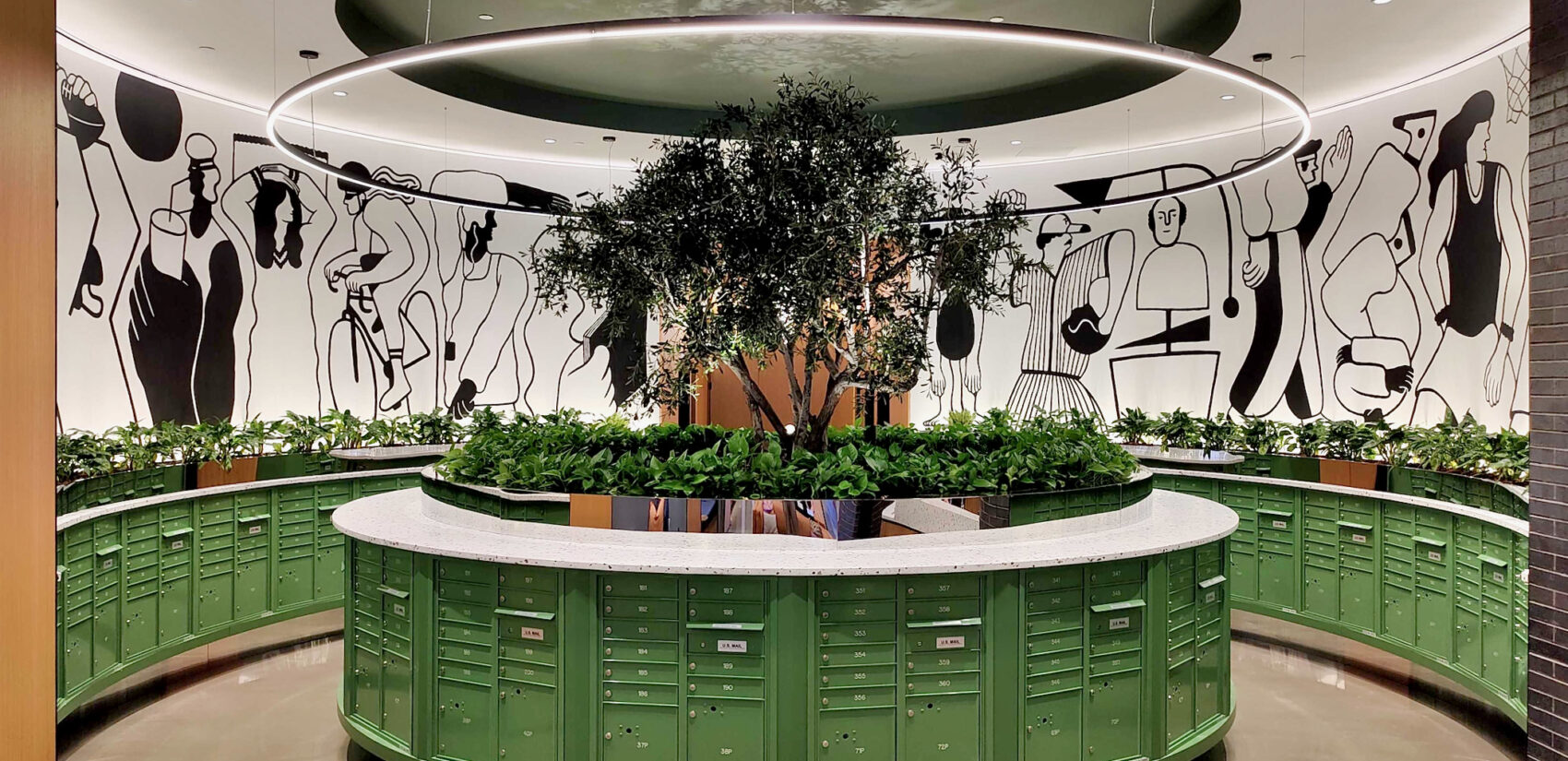 The mailbox room inside The Noble features a mural in-the-round by Philadelphia artist Nate Harris. (Peter Crimmins/WHYY)