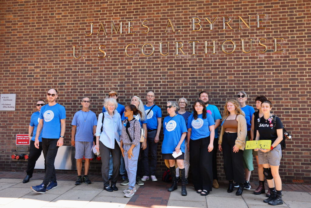 Former faculty posing for a photo outside the courthouse