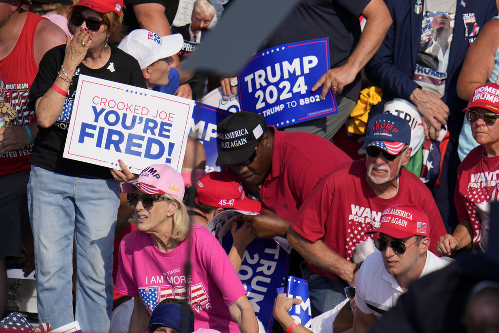 APTOPIX Election 2024 Trump Members of the crowd react as U.S. Secret Service agents surround Republican presidential candidate former President Donald Trump at a campaign event in Butler, Pa., on Saturday, July 13, 2024. (AP Photo/Gene J. Puskar)