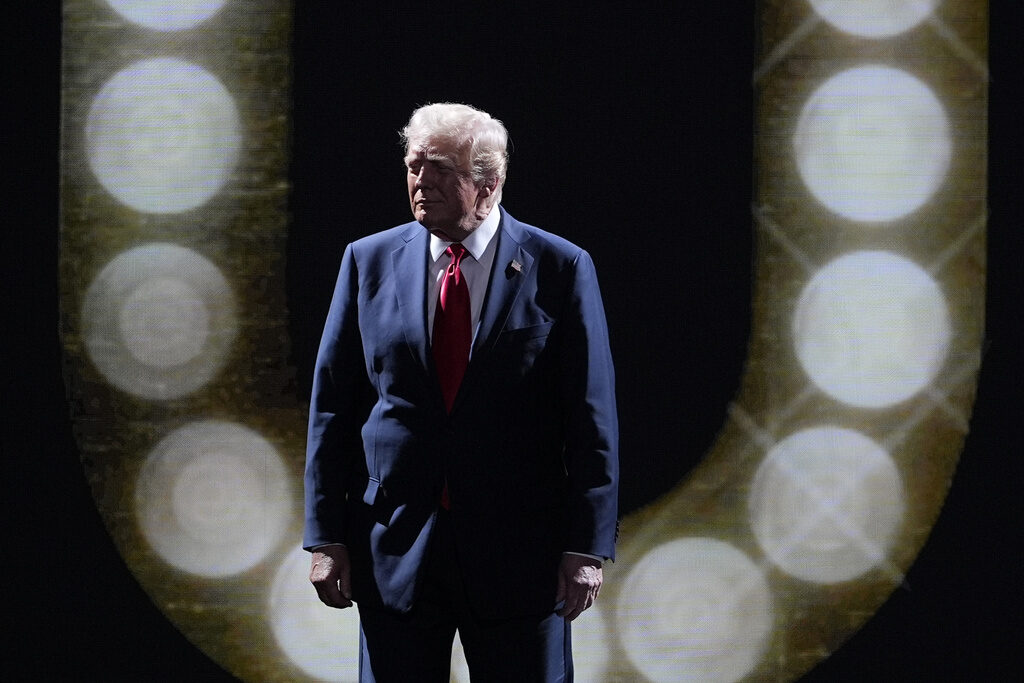 Election 2024 RNC Donald Trump stands in front of a ring of circular lights