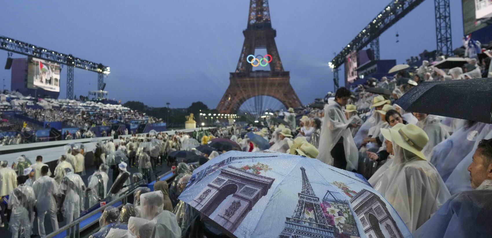 Spectators watch the opening ceremony of the 2024 Summer Olympics in Paris, France, Friday, July 26, 2024. (AP Photo/Thibault Camus)