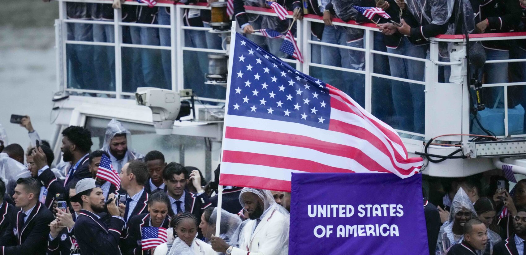 United States' Coco Gauff and Lebron James, bottom center, travel with teammates along the Seine River in Paris, France, during the opening ceremony of the 2024 Summer Olympics, Friday, July 26, 2024. (AP Photo/Kirsty Wigglesworth)