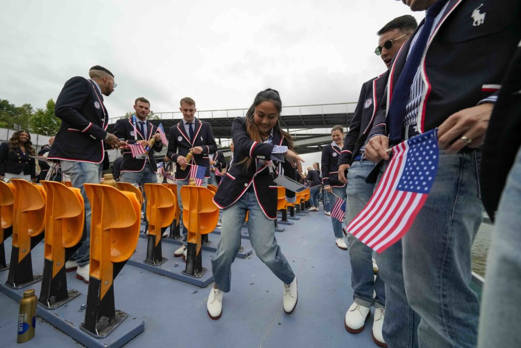 APTOPIX Paris Olympics Opening Ceremony Logan Edra, of the United States breakdancing team, dances as she travels along with teammates on the Seine River in Paris, France, during the opening ceremony of the 2024 Summer Olympics, Friday, July 26, 2024. (AP Photo/Ashley Landis, Pool)