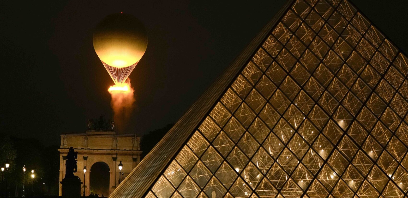The Olympic Flame rises on a balloon after being lit in Paris, France, during the opening ceremony of the 2024 Summer Olympics, Friday, July 26, 2024. (AP Photo/Francisco Seco)