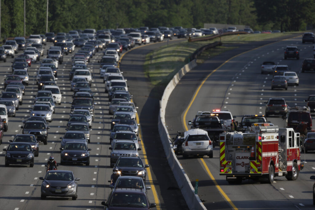 Parkway Accident An emergency vehicle, bottom right, stands near the scene of a two-vehicle accident on the southbound side of the Garden State Parkway in Clark, N.J. (AP Photo/Julio Cortez)