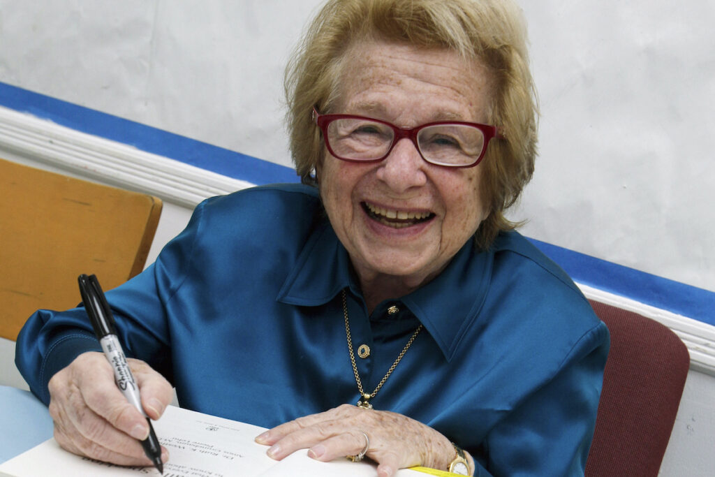 FILE - Dr. Ruth Westheimer signs a copy of her book 
