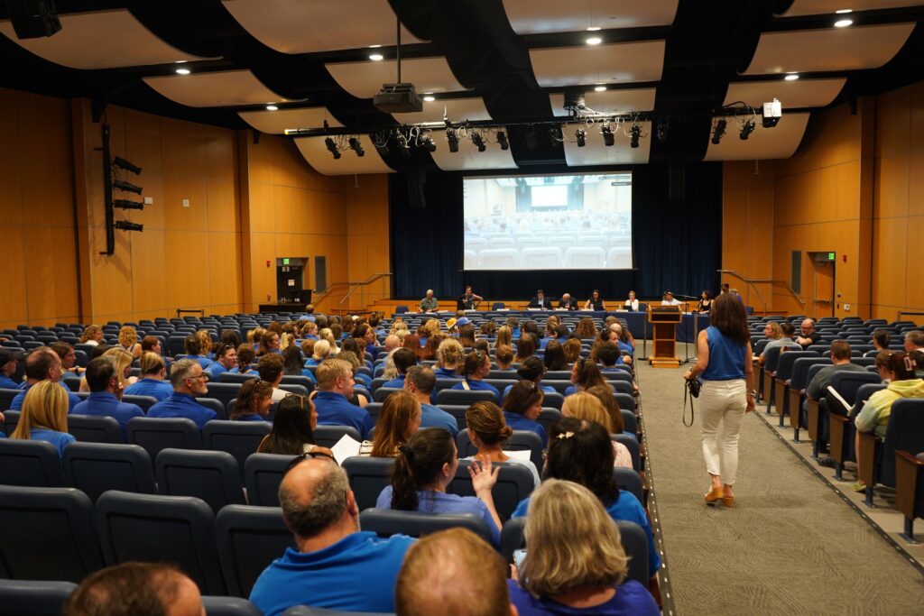 Great-Valley-School-District-tiktok-controversy-2 Great Valley Education Association President Nikki Salvatico walks down the aisle in the auditorium after ushering the other teachers in. (Kenny Cooper/WHYY News)