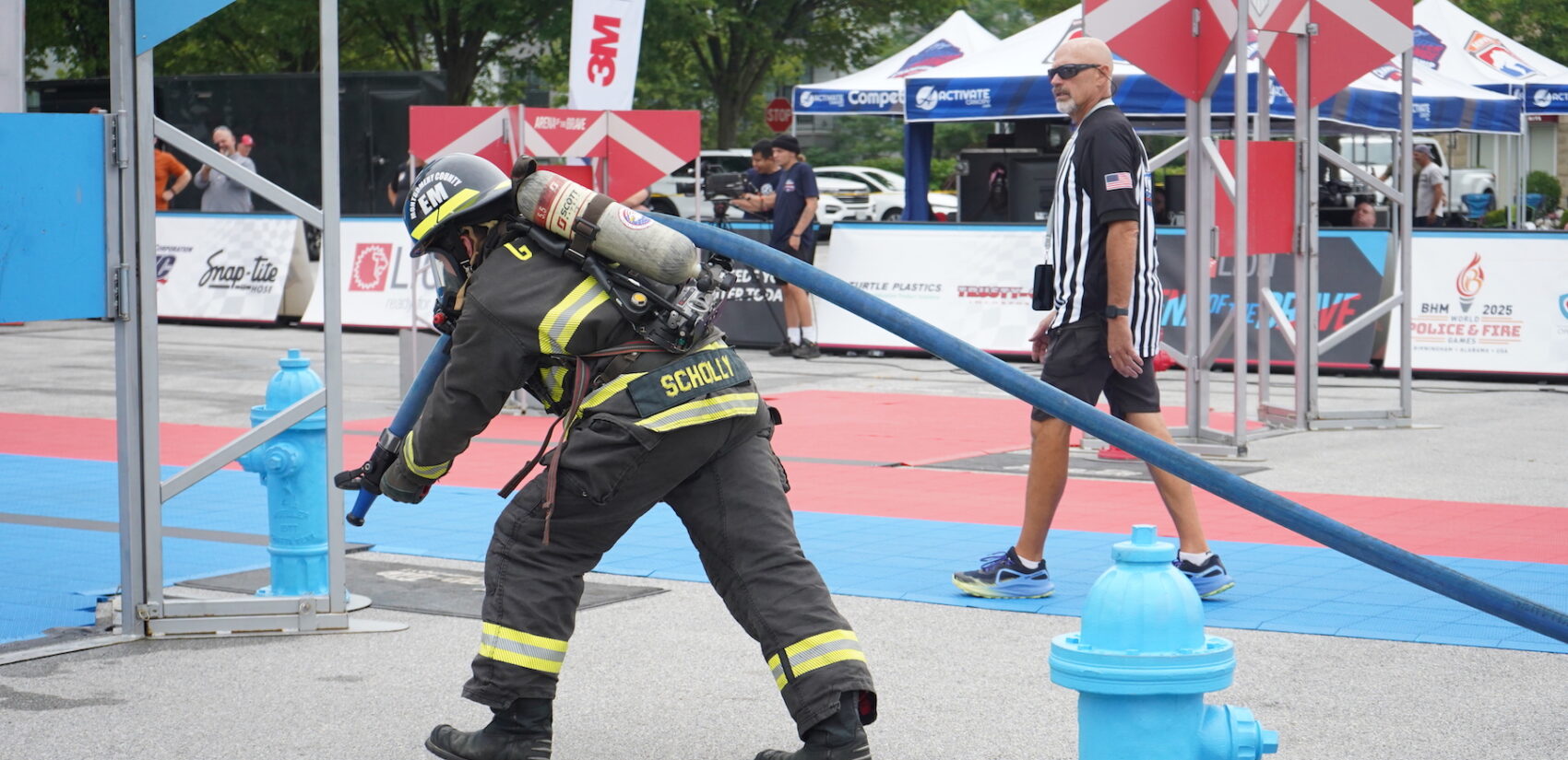 Jimmy Scholly pulling a fire hose through the course