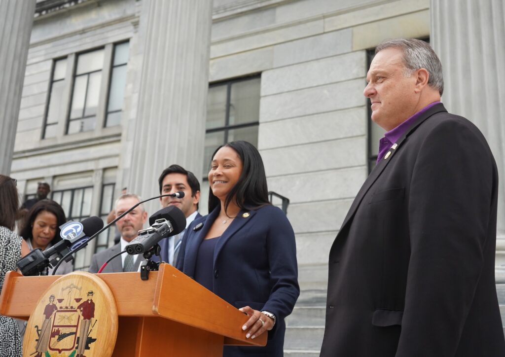 Montgomery County Commissioners Neil Makhija, Jamila Winder and Tom DiBello line up behind the lectern outside of the county courthouse in Norristown Neil Makhija, Jamila Winder and Tom DiBello